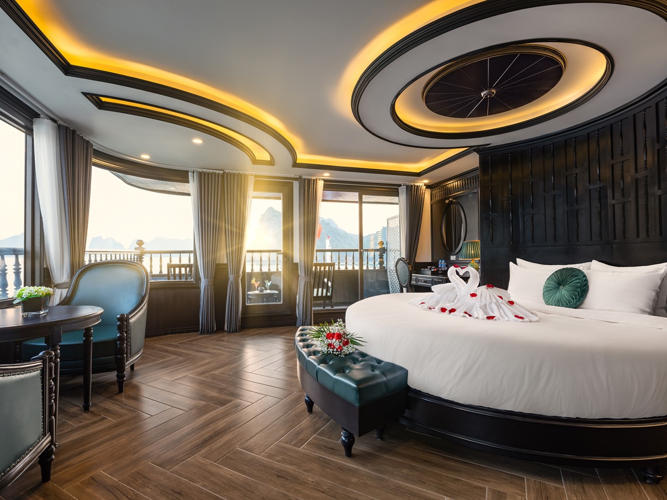 Luxurious cruise balcony with stunning views of Halong Bay at sunset.
