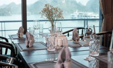 Luxurious cruise balcony with scenic Halong Bay views, perfect for relaxing and enjoying the sea bre.