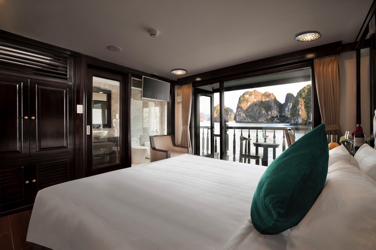 Elegant cruise balcony overlooking Halong Bay's stunning limestone karsts, perfect for a romantic ge.