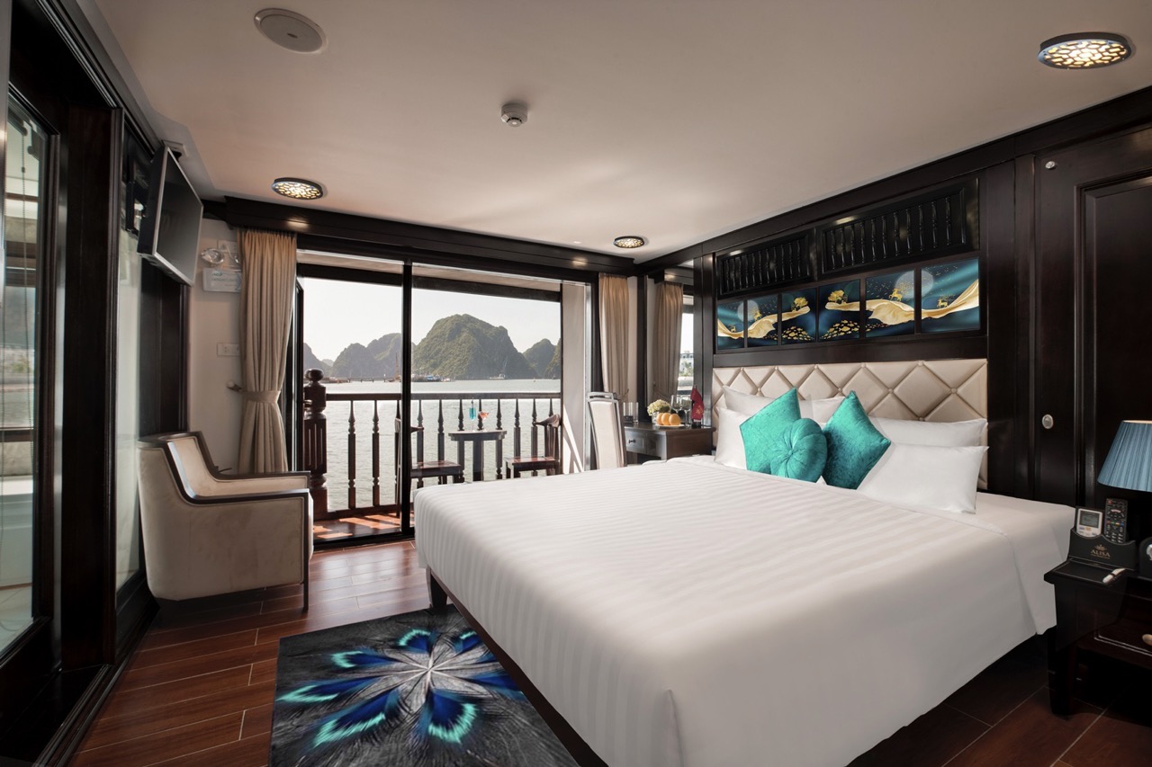 Elegant cruise room overlooking Halong Bay with panoramic water views and modern amenities.