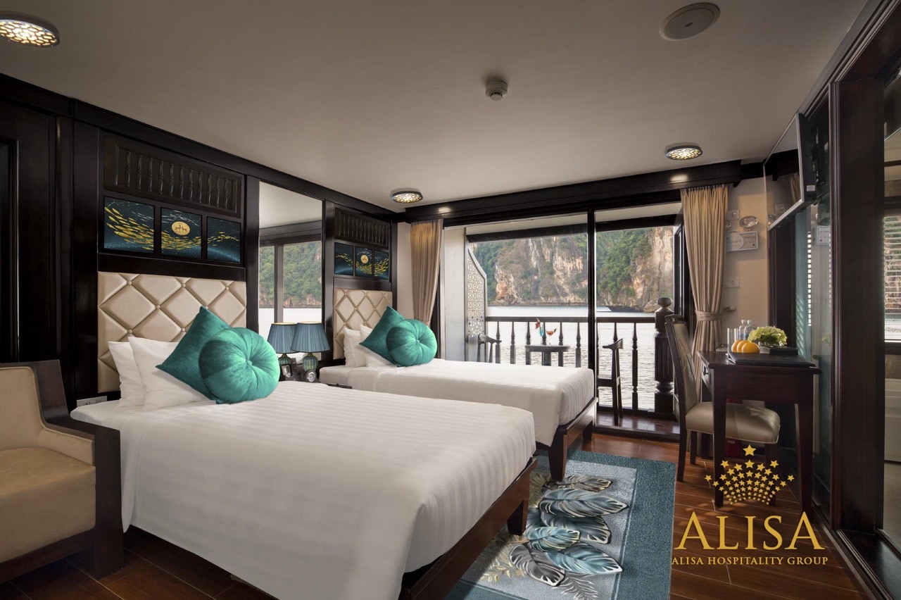 Luxury cruise balcony overlooking Halong Bay with stunning views and elegant decor.