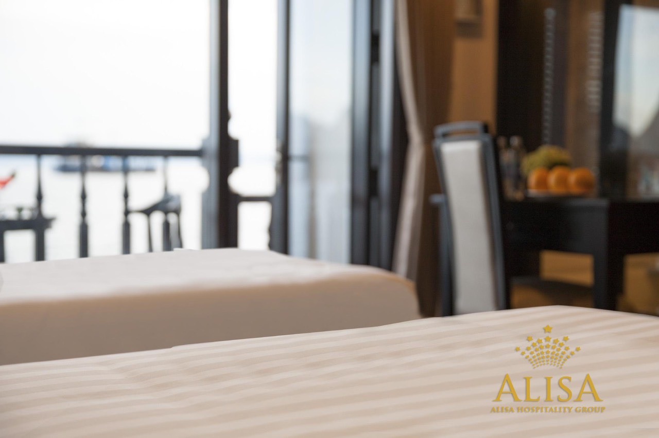 Scenic cruise balcony view over Halong Bay with calm waters and limestone karsts, perfect for a luxu.