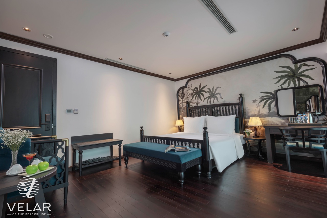 Luxurious cruise balcony room in Halong Bay with elegant decor and panoramic sea views.