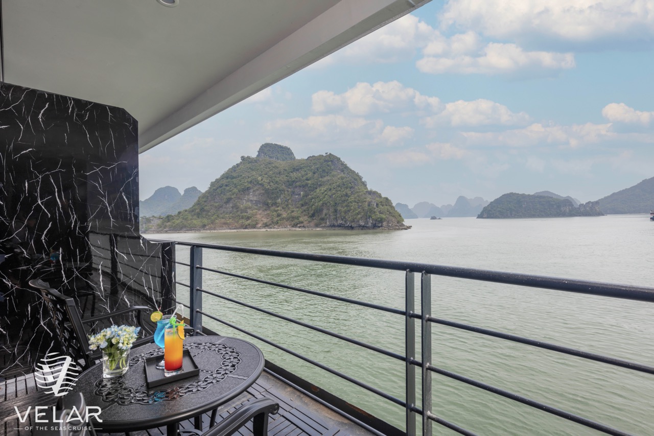 Scenic view of Halong Bay from cruise balcony with lush islands and calm waters, perfect for a luxur.