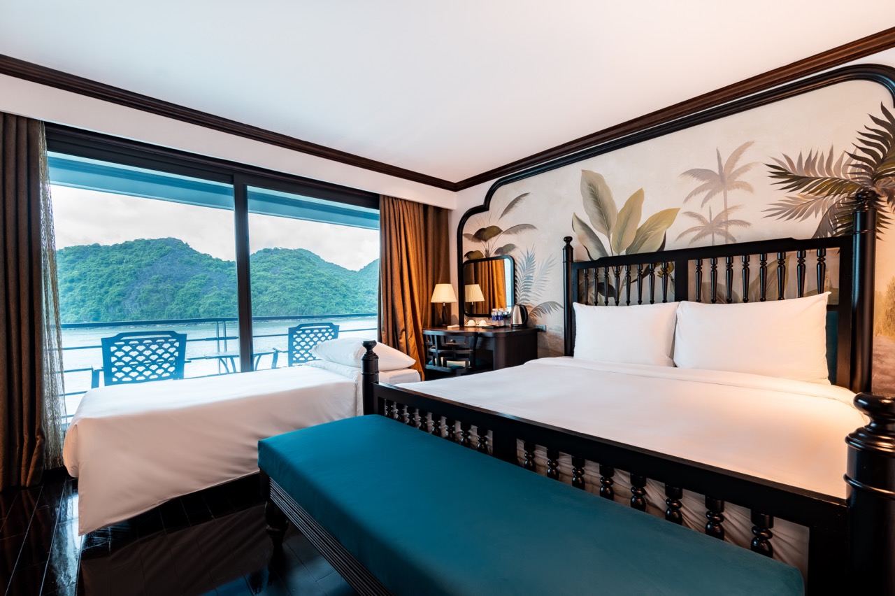 Stunning cruise balcony view of Halong Bay with lush islands and calm waters, perfect for a luxuriou.