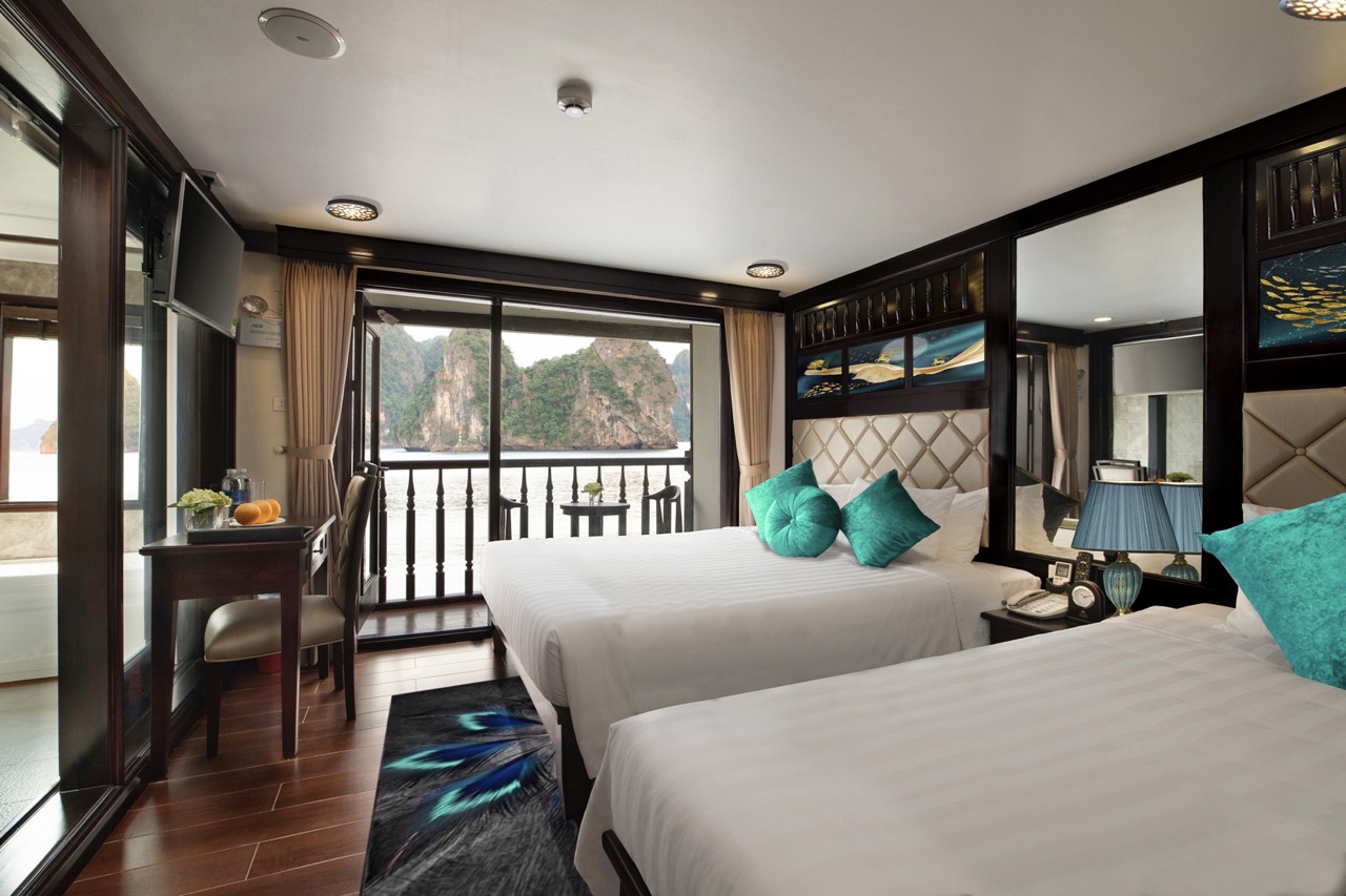 Stunning cruise balcony view of Halong Bay with clear waters and limestone karsts, perfect for a mem.