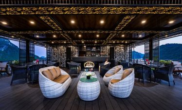 Luxurious cruise lounge with panoramic views of Halong Bay, perfect for relaxing and enjoying the sc.