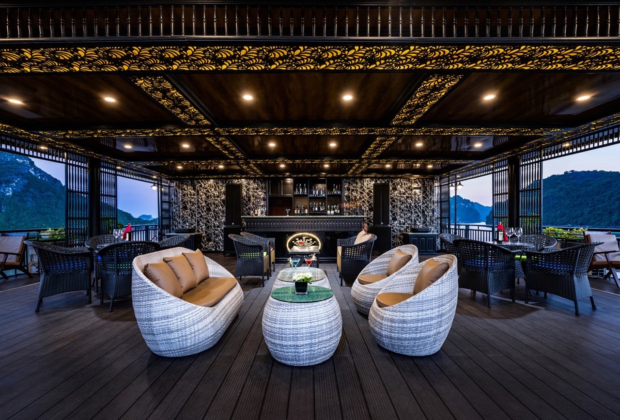 Luxurious cruise lounge with panoramic views of Halong Bay, perfect for relaxing and enjoying the sc.