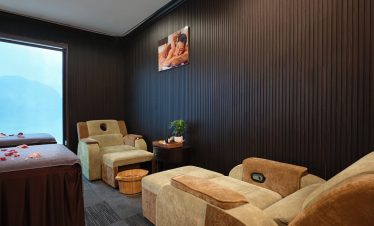 Relaxing cruise cabin with comfortable seating and scenic view of Halong Bay, perfect for a memorabl.