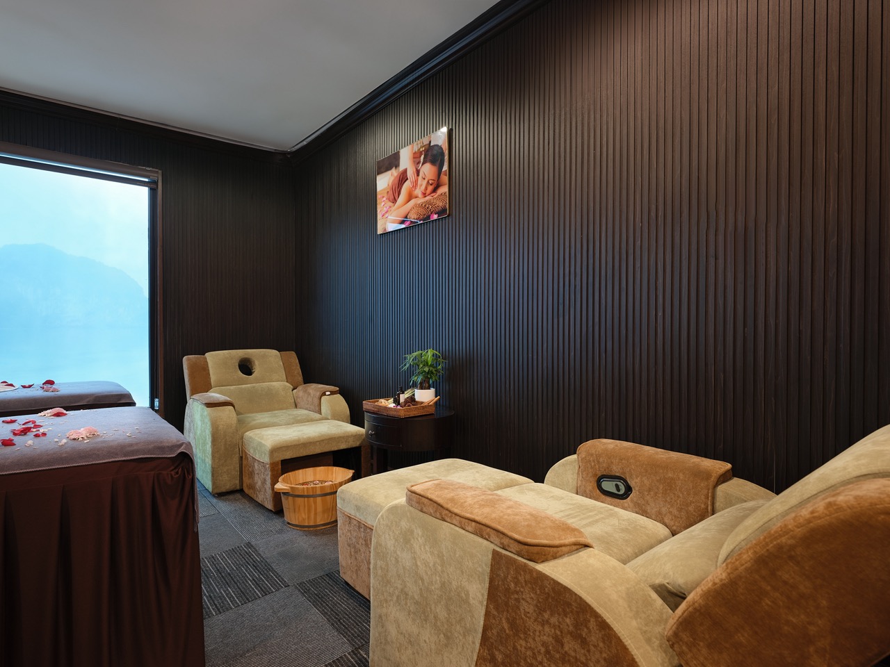 Relaxing cruise cabin with comfortable seating and scenic view of Halong Bay, perfect for a memorabl.