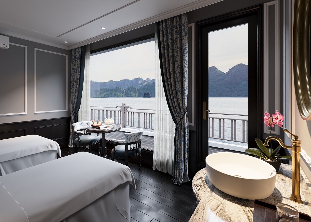Scenic view of Lan Ha Bay from a luxurious cruise cabin with large windows and elegant decor.