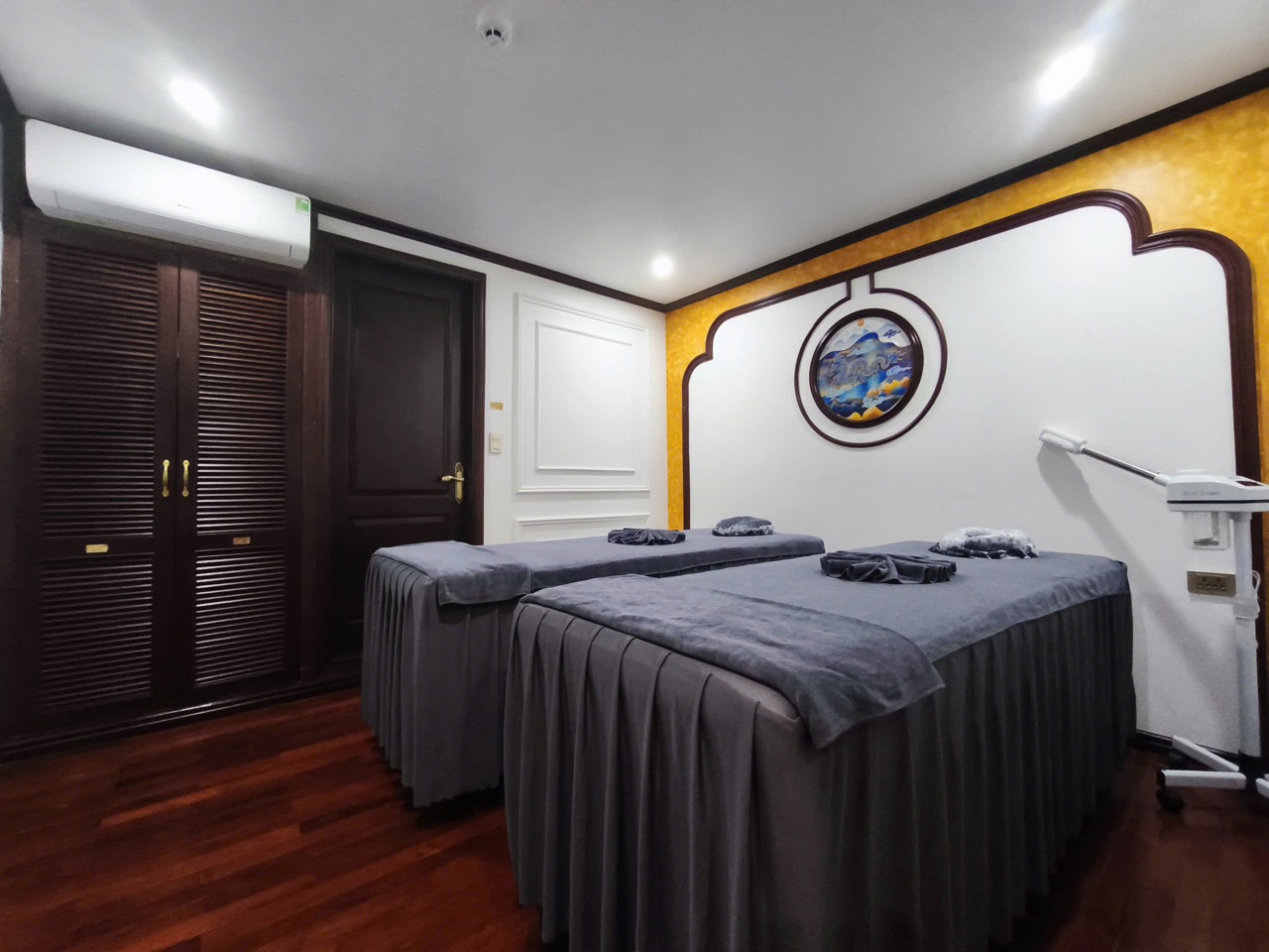 Interior of luxurious cruise cabin with twin beds and modern amenities.