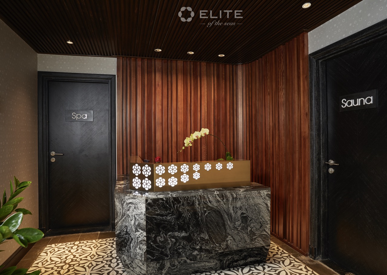 Elegant cruise lounge with wooden paneling and relaxing ambiance in Halong Bay.