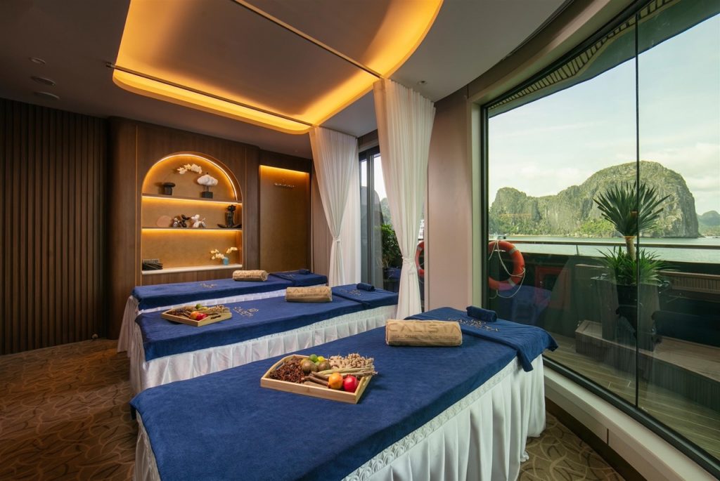 Stunning Halong Bay cruise balcony scene with lush green islands and calm waters.