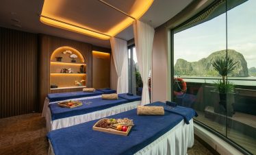 Stunning Halong Bay cruise balcony scene with lush green islands and calm waters.