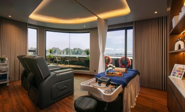 Stunning cruise balcony view of Halong Bay with modern amenities and panoramic windows.