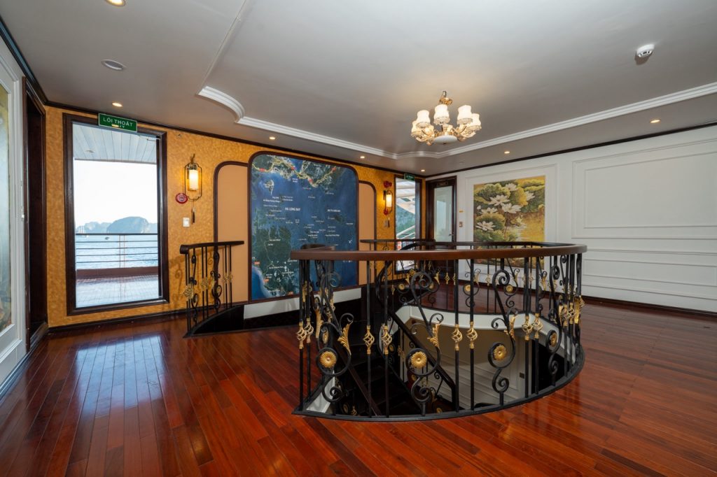 Stunning cruise interior with elegant decor and panoramic views of Bai Tu Long Bay.