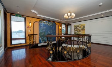 Stunning cruise interior with elegant decor and panoramic views of Bai Tu Long Bay.