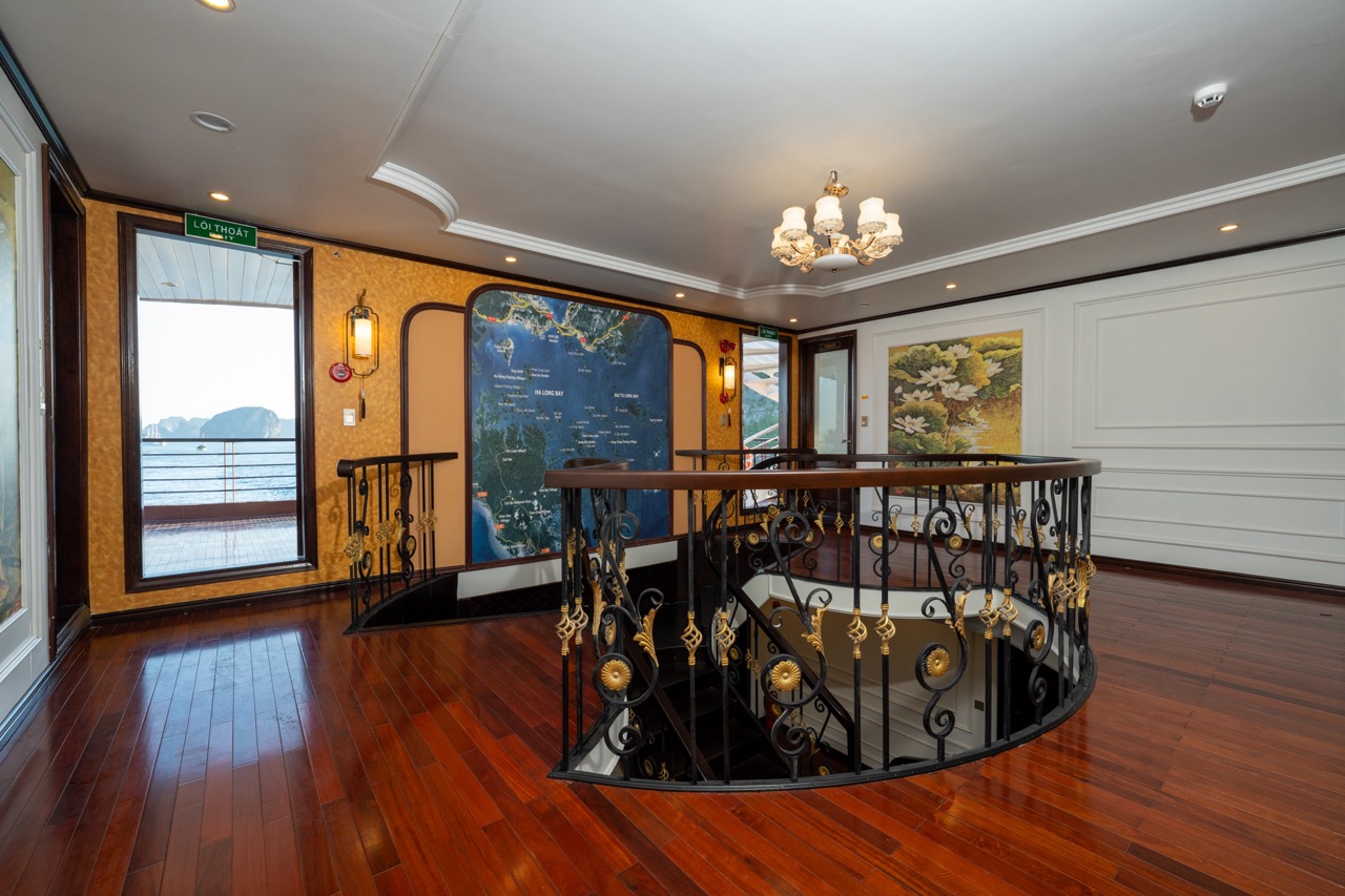 Stunning cruise interior with elegant decor and panoramic views of Bai Tu Long Bay.