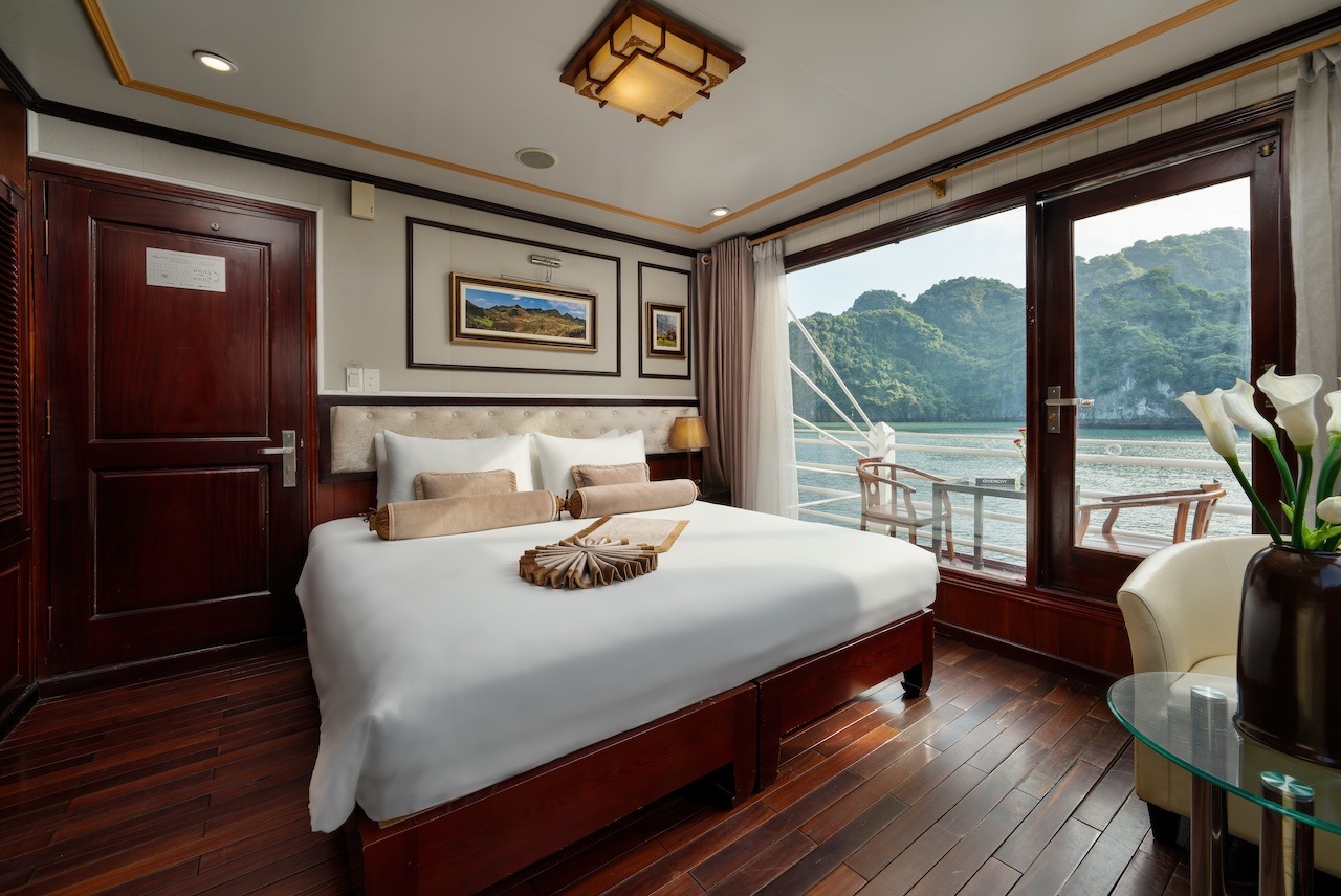 Elegant cruise cabin with panoramic bay views, perfect for a relaxing Halong Bay cruise experience.