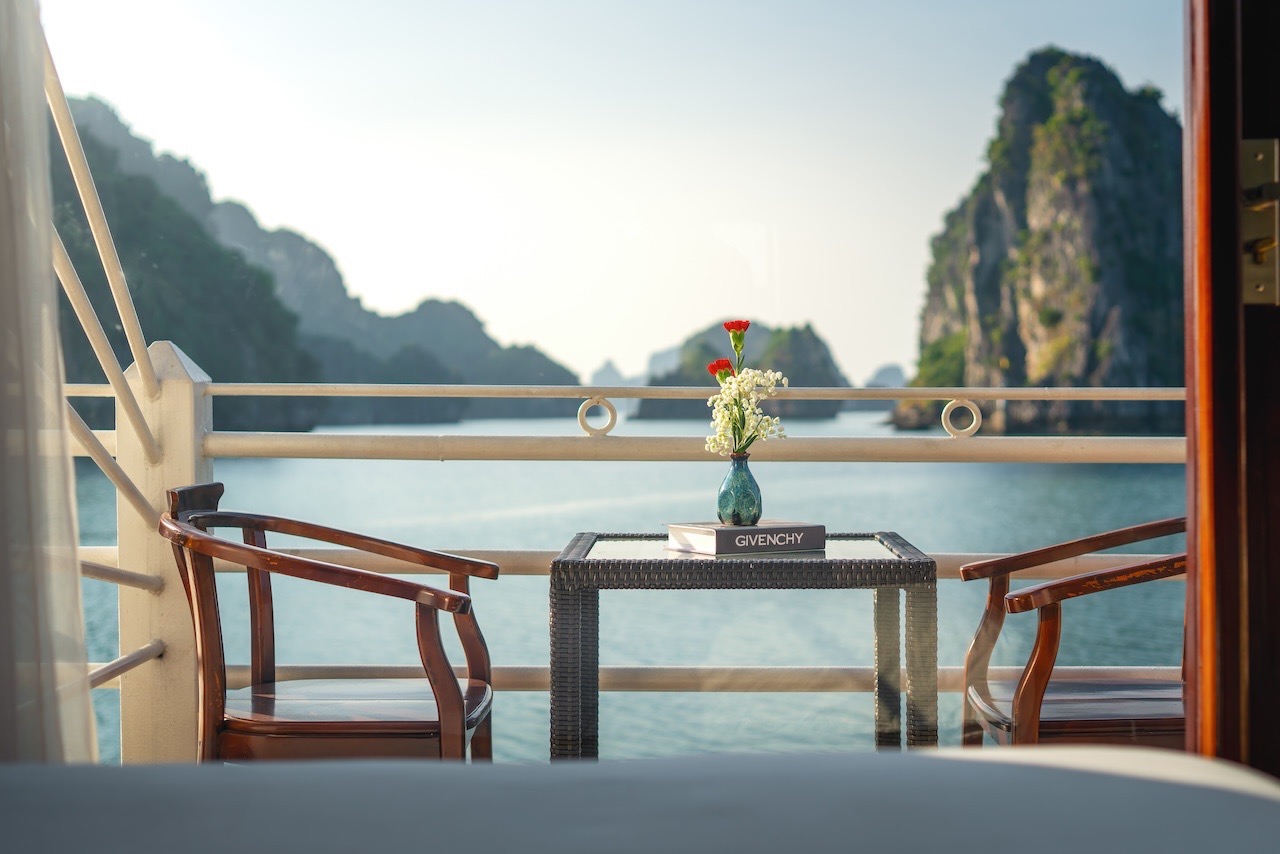 Beautiful view of Halong Bay from cruise balcony with scenic limestone karsts and tranquil waters, p.