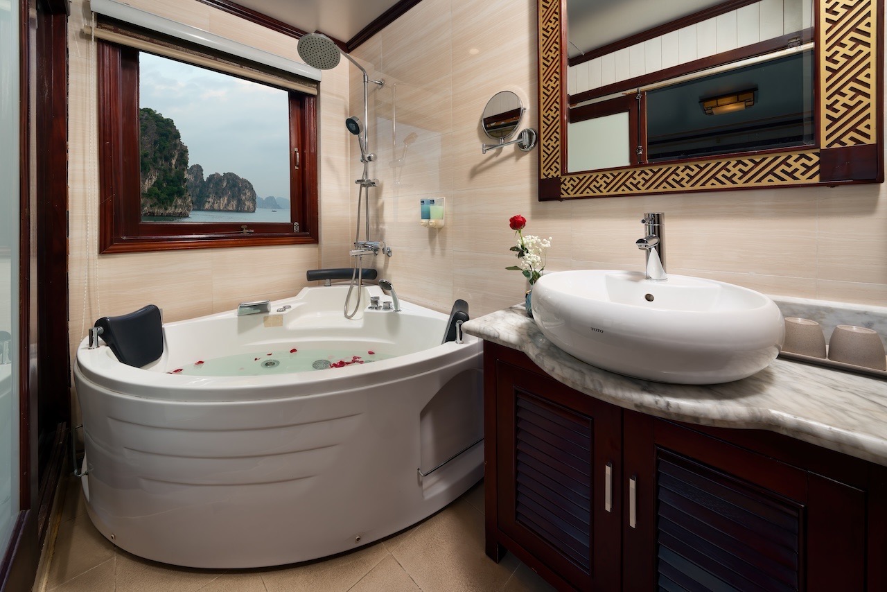 Elegant cruise cabin with modern amenities and scenic bay views in Halong Bay.