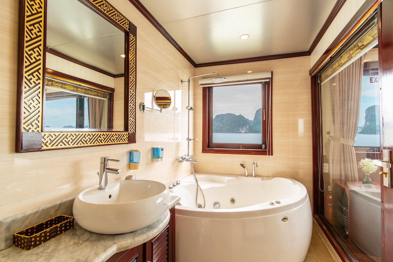 Scenic view of Halong Bay from cruise bathroom with modern amenities, perfect for a relaxing travel.