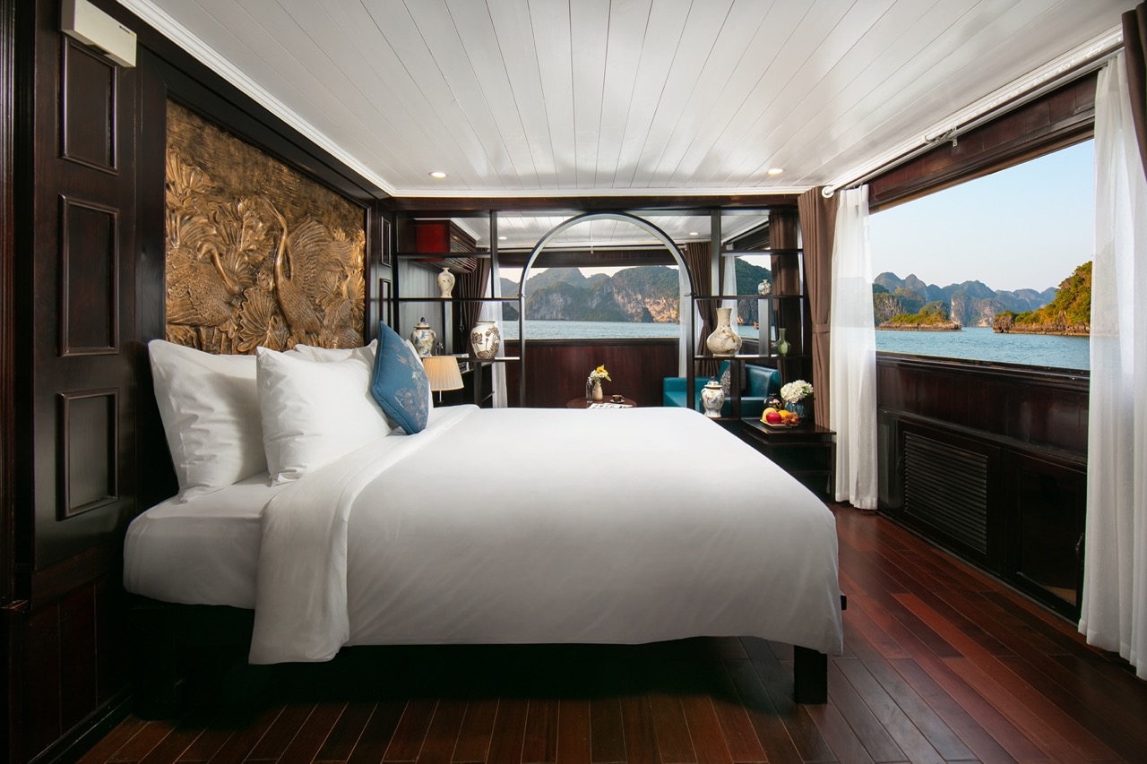 Elegant cruise balcony view of Halong Bay with scenic limestone karsts and tranquil waters.