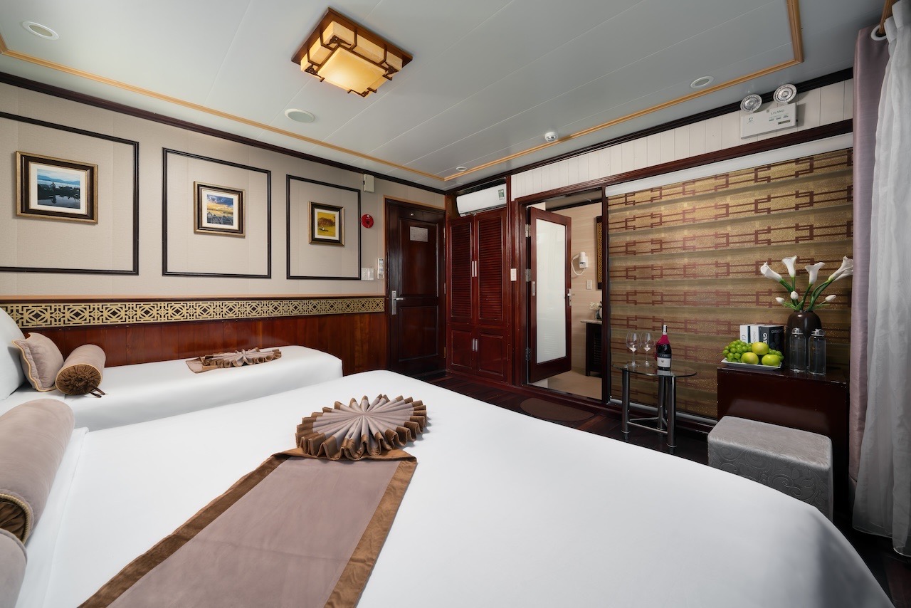 Luxurious cruise room with elegant decor and panoramic views of Halong Bay, perfect for a memorable.