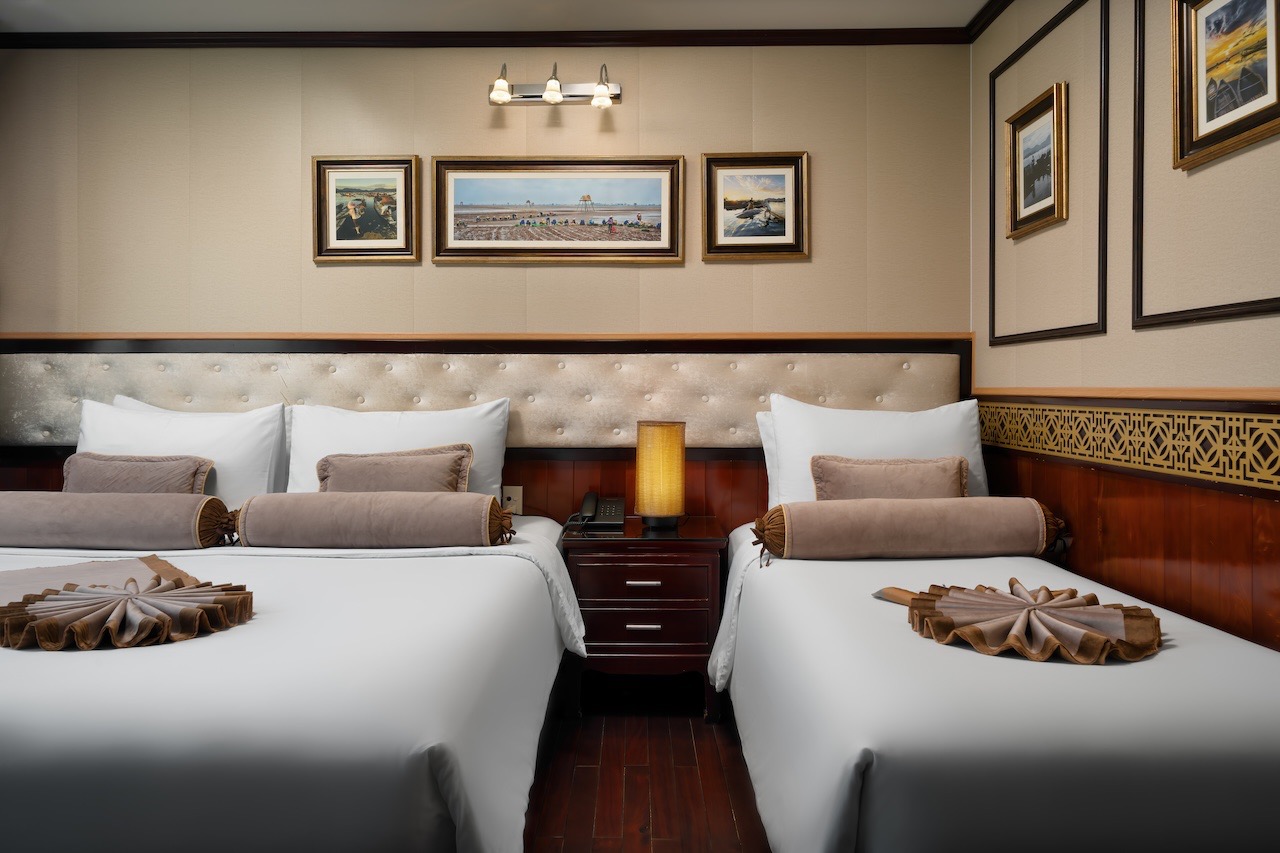 Luxurious Halong Bay cruise balcony with elegant decor and cozy beds, perfect for a memorable 2D1N e.