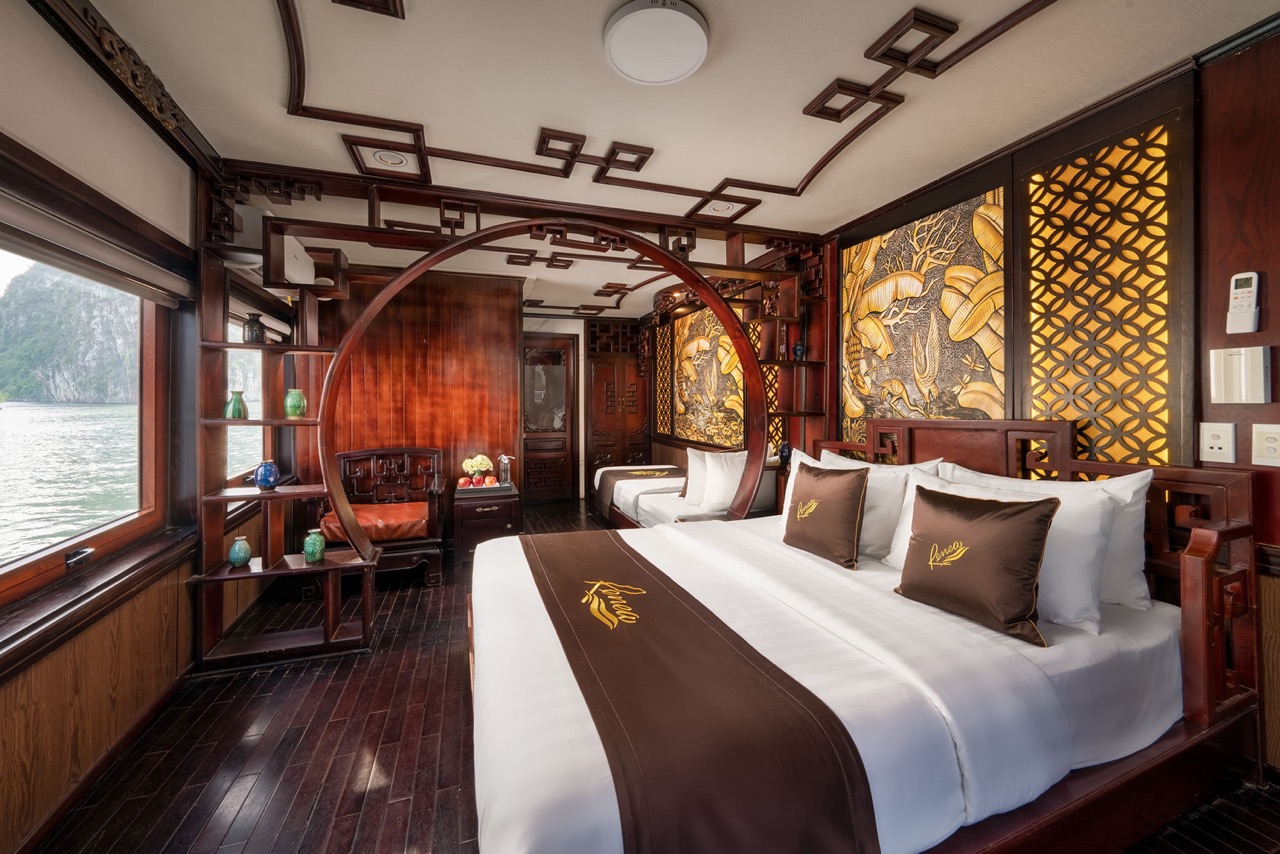 Elegant cruise cabin with traditional Asian decor and panoramic bay views.