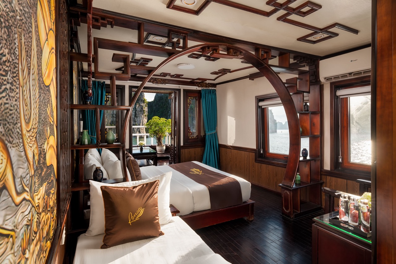 Elegant cruise cabin with modern decor and panoramic bay views in Bai Tu Long Bay.