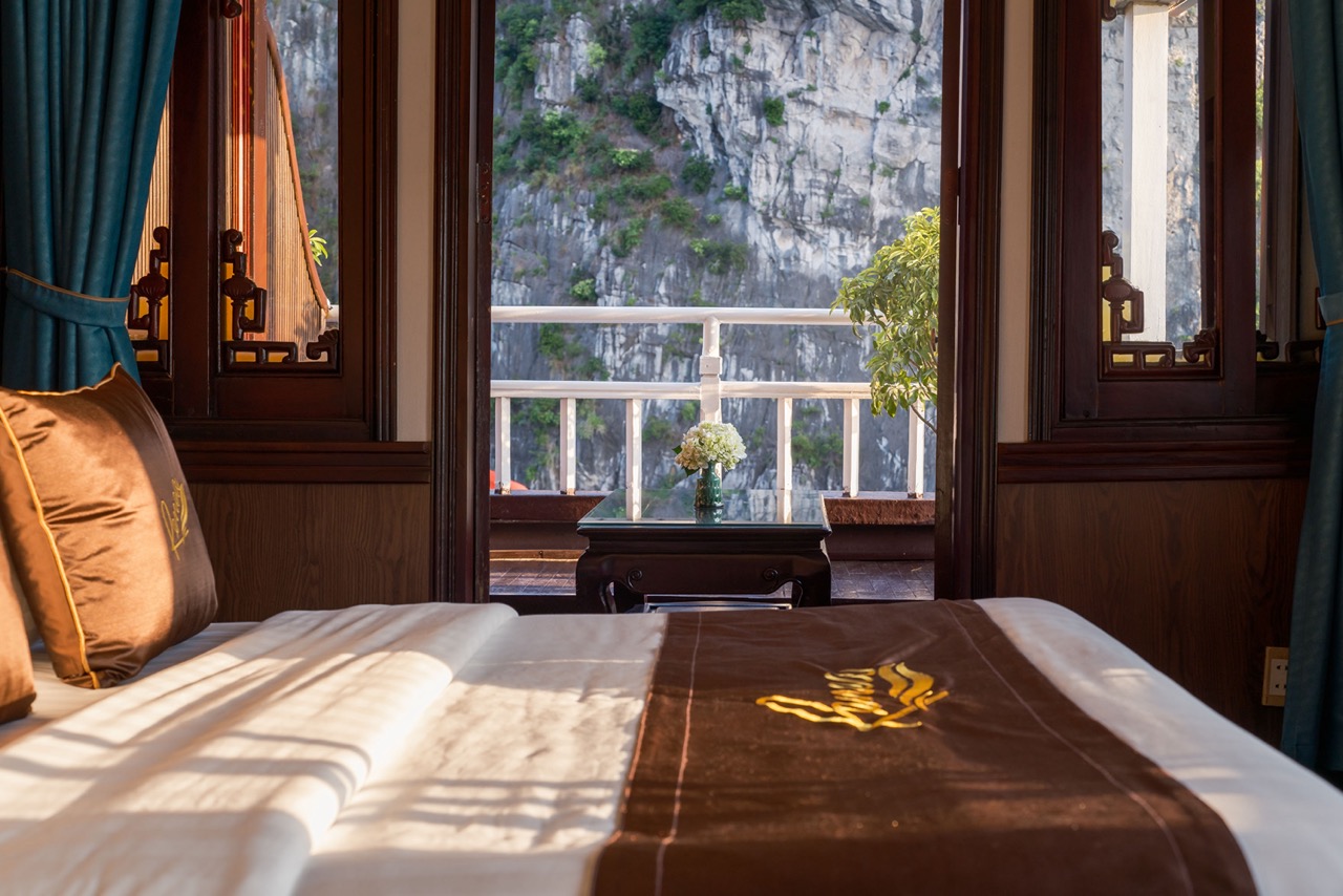 Stunning view from a luxury cruise balcony in Halong Bay, showcasing majestic limestone karsts and t.