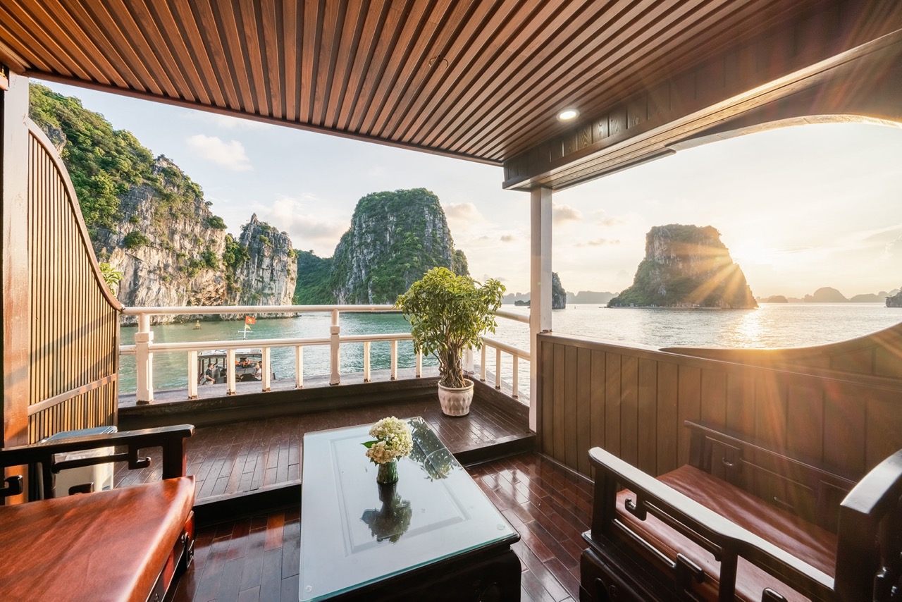 Enjoy breathtaking views of Halong Bay from your luxurious cruise balcony, perfect for a relaxing ge.