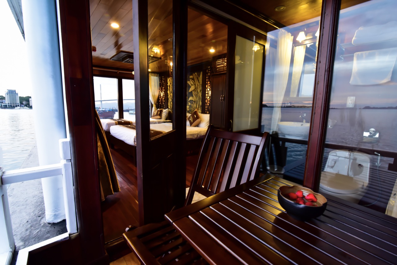 Stunning view from cruise balcony in Halong Bay with serene waters and lush islands.