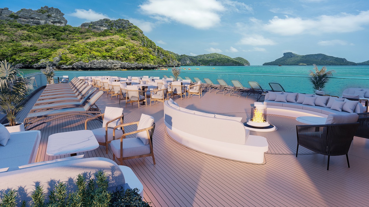 Luxurious oceanview cruise deck with lounge chairs and fire pit in tropical paradise.