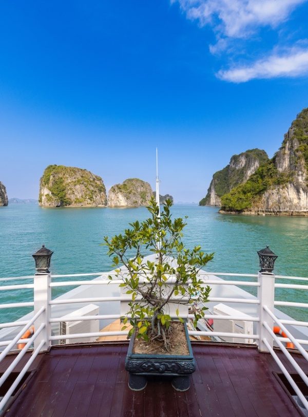 Stunning view from a cruise balcony in Halong Bay with turquoise waters and limestone islands, perfe.