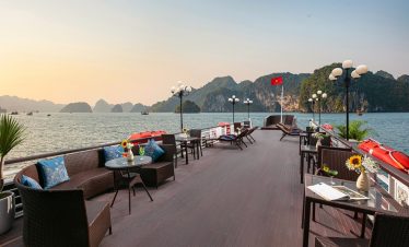 Scenic Halong Bay cruise deck with ocean views, perfect for relaxing and enjoying the sunset. Ideal.
