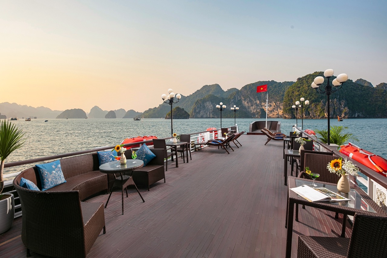 Scenic Halong Bay cruise deck with ocean views, perfect for relaxing and enjoying the sunset. Ideal.
