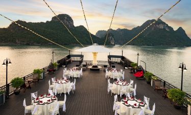 Stunning sunset view from a luxury cruise balcony in Halong Bay, perfect for relaxing and sightseein.