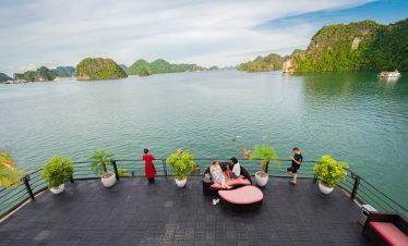 Stunning view of Halong Bay from the cruise balcony with travelers enjoying the scenic landscape and.