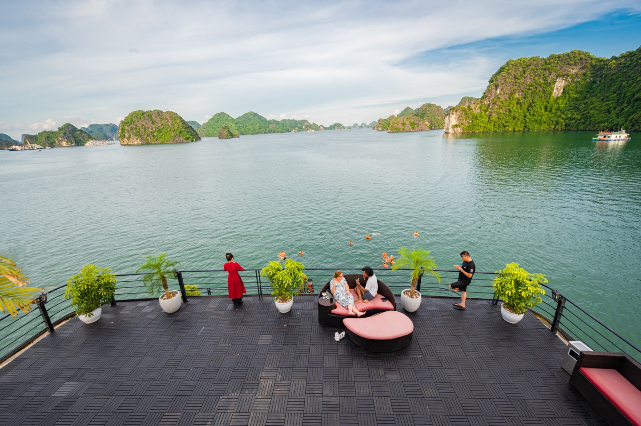 Stunning view of Halong Bay from the cruise balcony with travelers enjoying the scenic landscape and.