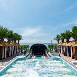 Luxurious rooftop infinity pool with tropical cabanas and scenic ocean views.