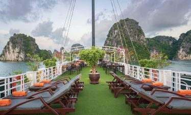 Stunning view of Halong Bay with limestone karsts and calm waters from the cruise deck.