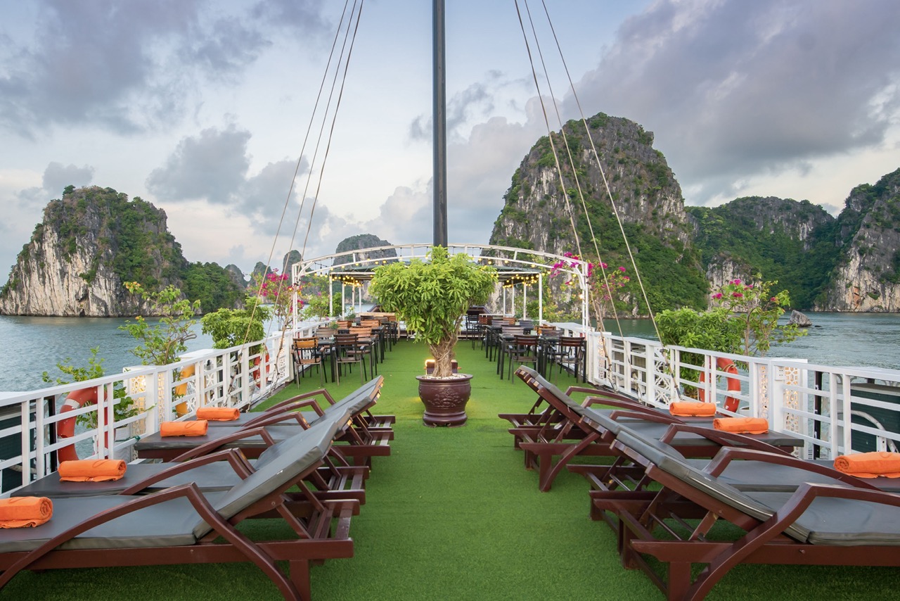 Stunning view of Halong Bay with limestone karsts and calm waters from the cruise deck.