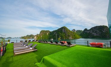 Relaxing cruise deck with scenic Halong Bay views, perfect for sunbathing and enjoying the tranquil.