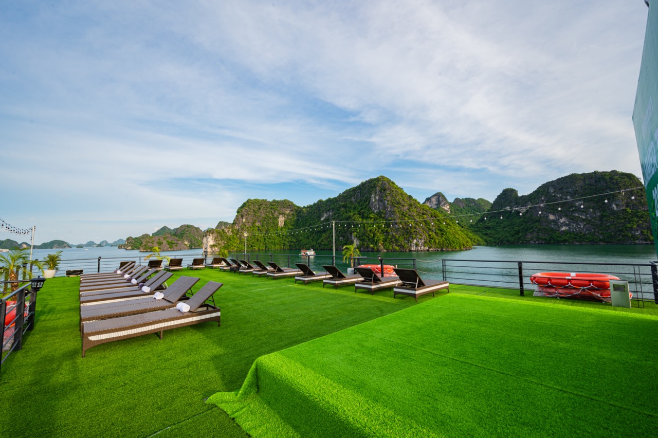 Relaxing cruise deck with scenic Halong Bay views, perfect for sunbathing and enjoying the tranquil.
