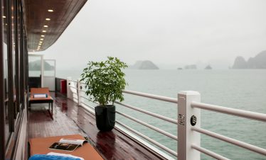 Balcony view of Halong Bay with calm waters and distant islands, perfect for a luxurious cruise expe.