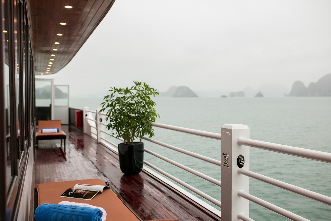 Balcony view of Halong Bay with calm waters and distant islands, perfect for a luxurious cruise expe.