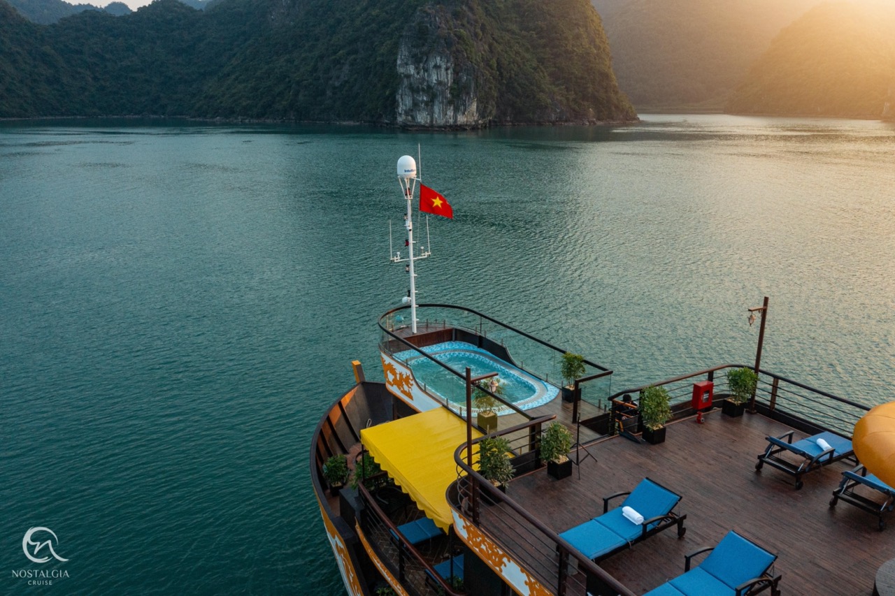 Stunning view from cruise balcony in Halong Bay with calm waters and lush islands.